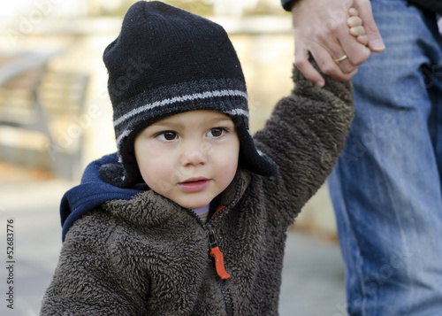 Photo: Baby or toddler child holding hand with parent. Baby or toddler child holding hand with parent.