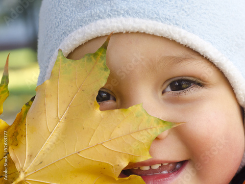 Photo: Portrait of a child with autumn or fall leave. Portrait of a child with autumn or fall leave.