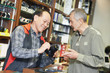 Seller demonstrating photo camera to buyer