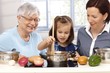 Three generations playing cooking
