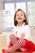 Happy little girl laughing in tailor seat