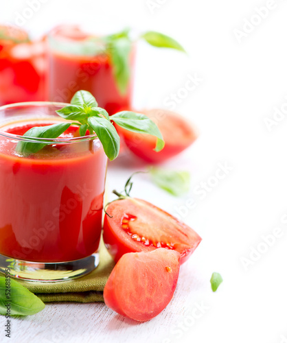 Photo: Tomato Juice and Fresh Tomatoes isolated on a White Background Tomato Juice and Fresh Tomatoes isolated on a White Background