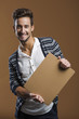 Photo: Young man holding a card board Young man holding a card board