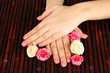 Woman hands with pink manicure and flowers,