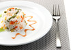 Delicious risotto with vegetables, isolated on white
