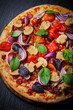 Foto: Homemade pizza with dried tomatoes and salami Homemade pizza with dried tomatoes and salami