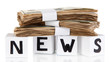 White paper cubes labeled "News" with money isolated on white