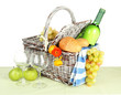 Picnic basket with fruits and bottle of wine, isolated on white