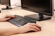 Female hands typing on keyboard