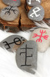 Fortune telling  with symbols on stones on white fur background