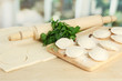 Raw dumplings and dough, on wooden table