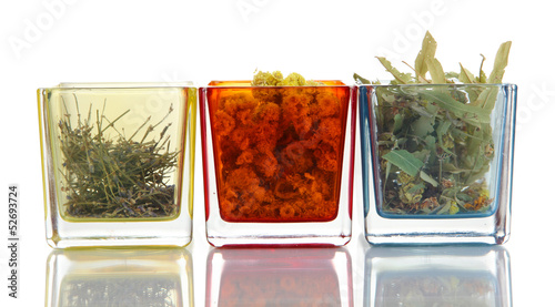 Photo: Dried herbs in glass containers isolated on white Dried herbs in glass containers isolated on white