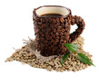 Cup of coffee beans and green beans isolated on white