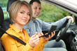 Portrait of young beautiful couple sitting in the car (woman