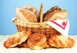 Composition with bread and rolls, in wicker basket