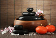 Spa stones with flowers and candles on bamboo background