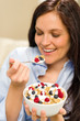 Dieting woman eating healthy cereal for breakfast