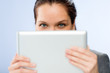Photo: Woman holding digital tablet hiding her face Woman holding digital tablet hiding her face