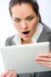 Amazed businesswoman holding tablet computer