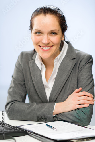 Photo: Confident smiling businesswoman looking at camera Confident smiling businesswoman looking at camera