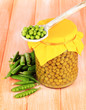 Green peas on wooden background