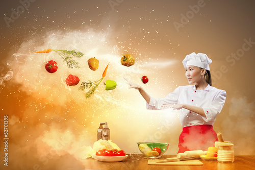 Photo: Asian female cooking with magic Asian female cooking with magic