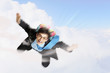 Young businessman flying with parachute on back