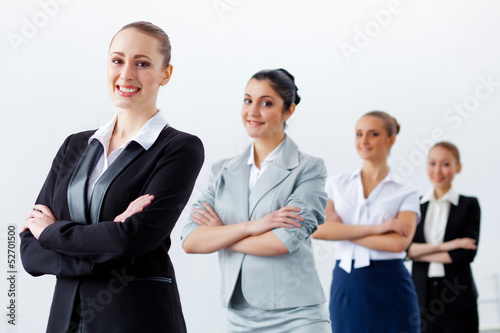 Photo: Four businesswomen standing in row Four businesswomen standing in row