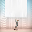 Businesswoman pulling blank banner