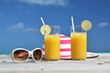 Sunglasses, hat and orange juice