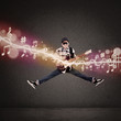 Photo: Acrobatic guitarist jumping with musical notes Acrobatic guitarist jumping with musical notes
