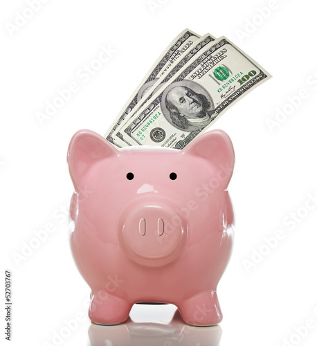 Photo: Pink piggy bank with hundred dollar bills Pink piggy bank with hundred dollar bills
