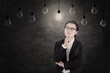 Businessman looking at lit lightbulb