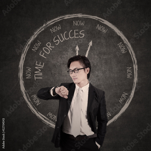 Photo: Businessman checking out his watch Businessman checking out his watch