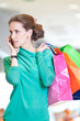 Foto: Shopping woman with phone and color bags Shopping woman with phone and color bags