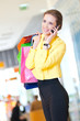 Foto: Shopping woman with phone and color bags Shopping woman with phone and color bags