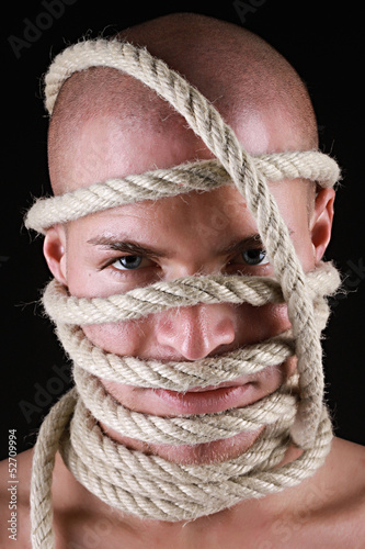 Photo: Portrait of a man with rope on his head Portrait of a man with rope on his head