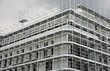 structure of a large skyscraper under construction with the lead