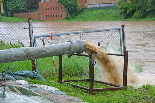 Photo: impressive exhaust flows into river rainwater and mud impressive exhaust flows into river rainwater and mud