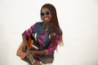 Beautiful african woman playing guitar