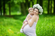 Pregnant mother and her daughter have fun outdoor