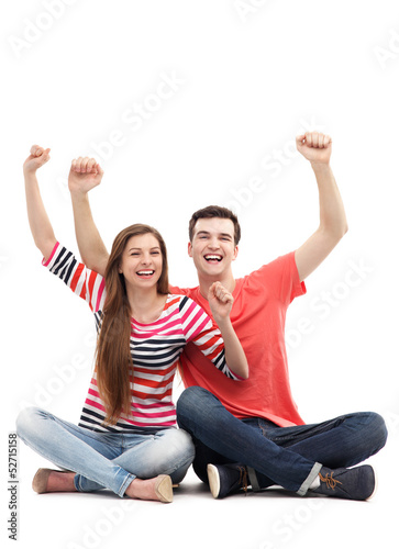 Photo: Young couple with arms raised Young couple with arms raised