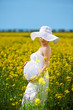 Pregnant caucasian woman takes rest outdoor