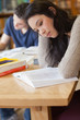 Student reading a book in a library
