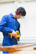 Photo: Student of a woodworking class drilling a hole Student of a woodworking class drilling a hole