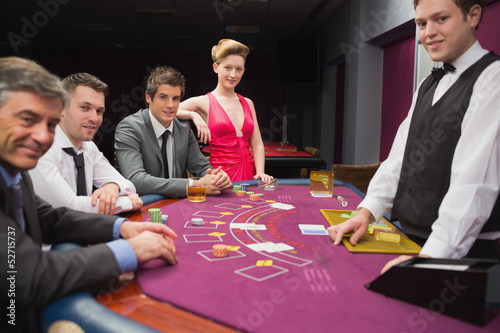 Photo: People sitting at blackjack table and smiling People sitting at blackjack table and smiling