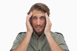 Man grimacing with pain of headache and looking up