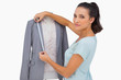 Designer measuring blazer on mannequin