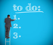 Businessman writing a to do list on a giant wall