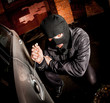 Photo: Car thief in a mask. Car thief in a mask.